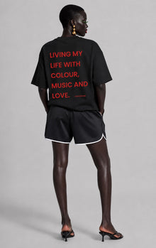 Female model showing back of CHINAKWE Live Life Green T-shirt